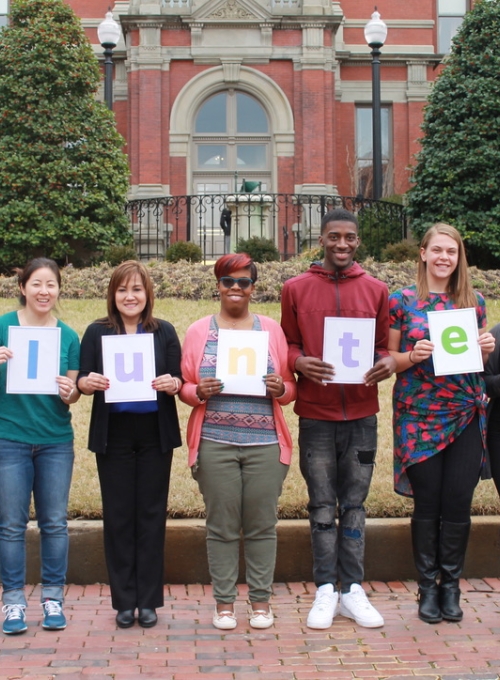 volunteers holding letters