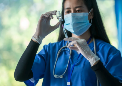 clinician drawing up vaccine